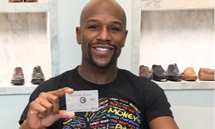 Floyd Mayweather holding the Centra Card